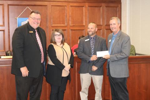 Sunshot by Grayson Williams - Superintendent Jay Floyd, from left, and Hart County Board of Education chairperson Kim Pierce, pose for a photo with Hart College and Career Academy CEO Brooks Mewborn as Mewborn accepts a donation from Georgia Power’s Kevin McCraney to help fund an aerodynamics lab at the academy. 