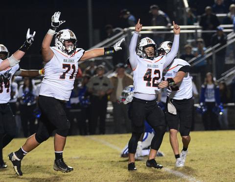 Sunshot by Michael Hall - Hart County kicker Tucker Kim, No. 42, raises his hands in victory along with Caden Hart, No. 71, while quarterback Luke Lee tackles Kim after Kim’s game winning field goal on Nov. 22 in Blackshear over the Pierce County Bears. 