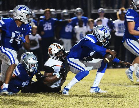 Hart County's Kaimon Rucker pulls down the Pierce County quarterback for a sack late in the game in Blackshear on Nov. 22 in the second round of the state playoffs. 