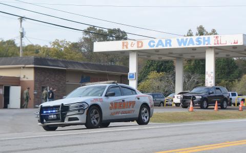 A Hart County deputy's car is parked at the entrance of R&D Car Wash on Anderson Highway as the GBI and other authorities investigate an alleged racketeering scheme they believe involves Hart County commissioner R.C. Oglesby. 