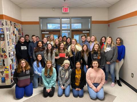 Photo submitted - Corrina Crumpton, in the middle holding an envelope, received tickets to swim with whale sharks at the Georgia Aquarium from her class after the students learned of her wish. 