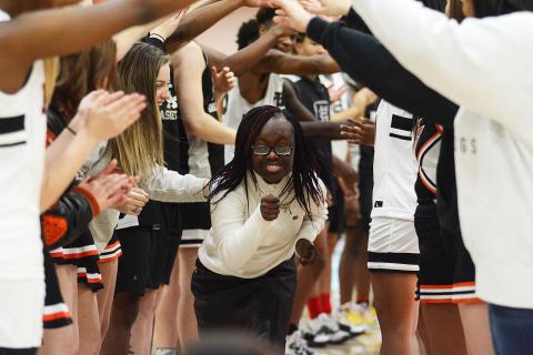 Sunshots by Grayson Williams — Briamah Edmond runs under an arch of hands made by basketball players and cheerleaders at Buddy Basketball on Dec. 16 at Hart County High School. 