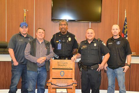 Sunshot by Drew Dotson — Eli Gomez, from left, Hart County Commissioner Ricky Carter, Hartwell Police Chief Anthony Davis, Royston police officer Rick Carter and Tony Capell pose for a photo with a chair donated by Gomez and Capell’s nonprofit, Saving a Hero’s Place.