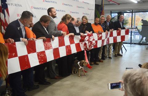 Sunshot from file - City, state and county officials along with representatives from Nestlé-Purina watch as a dog pulls the ribbon, officially opening the company’s Hartwell production facility in November. 