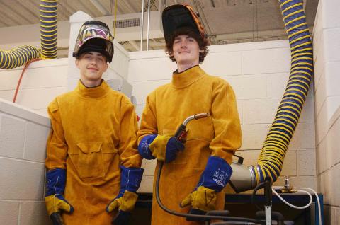 Sunshot by Michael Hall — Hart College and Career Academy students Zack Hart, left, and Austin Brown, right, pose for a photo in the welding lab at the school recently.  The pair were hired recently to work at Fabritex in Hartwell. 