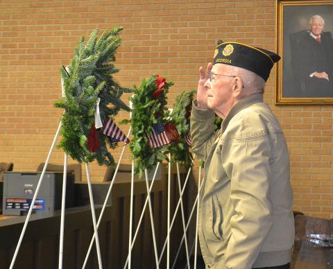 Sunshot from file — World War II Army veteran Harold “Andy” Anderson salutes during the presentation of the Wreaths Across America in December 2018 at the Hart County Courthouse.