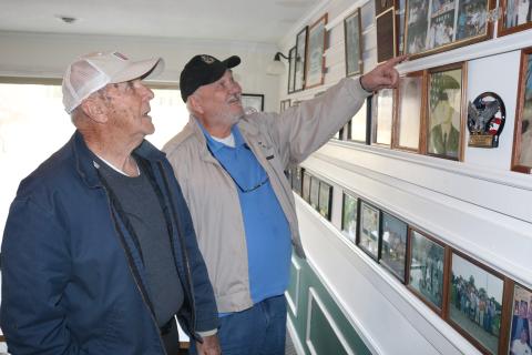 Sunshot by Grayson Williams - American Legion Post 109 members Charles Howard, left, and Sidney Reed, right, look at pictures on the wall at the Post’s clubhouse in Hartwell. 
