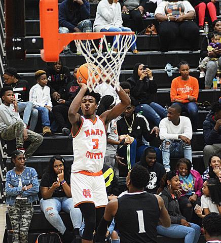Sunshot by Michael Hall - Hart County’s Tahj Johnson puts up a shot from the corner in the first half on Jan. 10 at Hart County High School. Johnson dropped a team high 23 points in the game, a majority of which came in the first half.