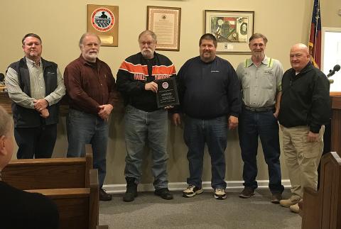 Joe Brantley, who is retiring, was awarded a plaque for his service as a long-time employee of the county. Pictured are county commissioners Ricky Carter, from left, and Marshall Sayer, Brantley, commission chairman Joey Dorsey, solid waste department head Greg Howell, and commissioner Frankie Teasley.