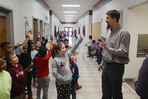 Sunshot by Michael Hall - Mark Seabolt, general manager of Dairy Queen in Hartwell, talks with first graders at Hartwell Elementary recently. 