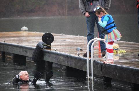 File photo submitted by Barbi Stowe - Aubrey Bailey, then 6, needed a little persuasion from safety diver Kinsey Craft to jump into the 54-degree water of Lake Hartwell at the 2019 Polar Bear Plunge, a benefit for the Northeast Georgia Council on Domestic Violence.