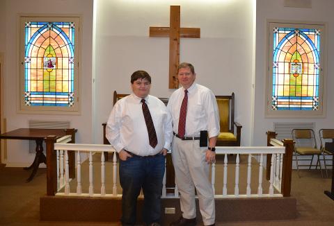 Sunshot by Drew Dotson - Matthew Strickland, left, and Arnold Strickland, right, pose for a photo in the chapel at Strickland Funeral Home in Hartwell. The funeral home is turning 45-years-old this year. 