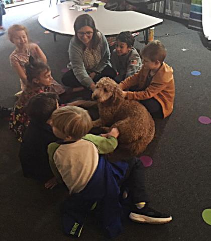 Photo submitted - Teacher Meghan Harris, center top, sits with students and Penelope the therapy dog recently at Hartwell Elementary School. 