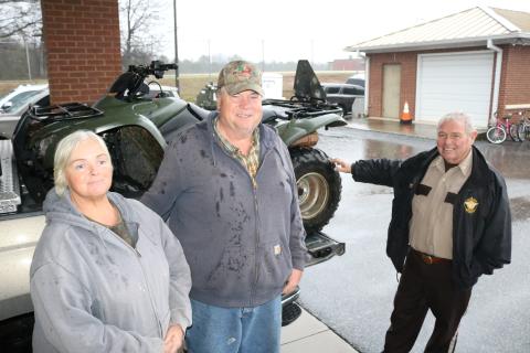 Sunshot by Grayson Williams - Janice Mize, left, and Tim Mize, middle, pose for photo with Sheriff Mike Cleveland at the Sheriff’s office recently with a four-wheeler that was recovered weeks after it was stolen.