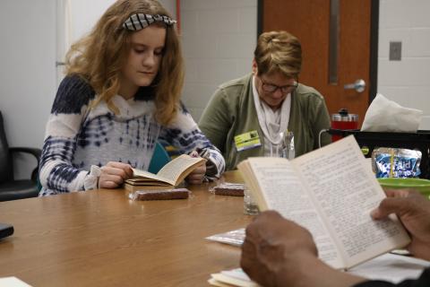 Sunshot by Grayson Williams - Abigail Ricketts, left, and Linda Mealor, right, read during a book club meeting at Hart County Middle School, organized by Hart Partners, reads “Where the Red Fern Grows” on Friday, Feb. 14 at the Middle School. 