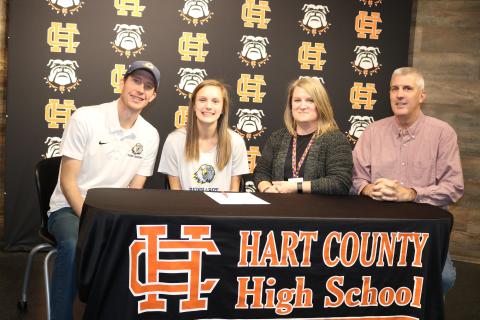 Sunshot by Grayson Williams Jillian Hoell second from left, signed on Jan. 31 to run cross country at Reinhardt University next season. Pictured are Reinhardt coach Jordan Turner, Hoell, her mother Sarah Hoell and father Roy Hoell. 