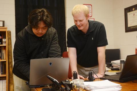Sunshot by Michael Hall - Hart County High School’s STAR student, Sean Pak, left, and STAR teacher, Rob Elliot, right, look over the coding of a video game last week they created along with the TSA video game competition team. 
