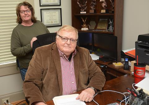 Sunshot by MIchael Hall - Angie McGee, owner of Wade’s Tax Service and Hartland Farm and Home Realty, back, and Wade Gaines, front, executive of the Warren Foundation Scholarships, are pictured in their offices on E. Franklin Street in Hartwell. 
