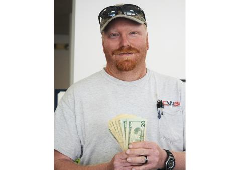 Sunshot by Michael Hall — Josh Owen shows off the $100 he won by submitting the winning photo for the Hello Hart cover photo contest. 