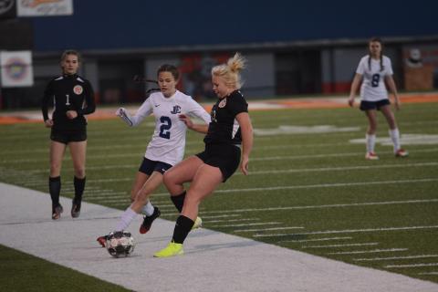 Sunshot by Grayson Williams - Skyler Chastain, right, battles for the ball with an East Jackson player on Friday, March 6 at Herndon Stadium as Evelyn Holmes, left, approaches.  