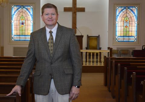 Sunshot by Michael Hall — Funeral director Arnold Strickland of Strickland Funeral Home stands in the empty chapel at his Hartwell location where funeral services are few and far between these days because of social distancing requirements issued by national, state and local governments.
