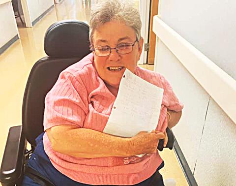 Photo submitted In this photo from Facebook, a Hart Care Center resident shows off a letter sent to her by a North Hart Elementary School first-grade student. 