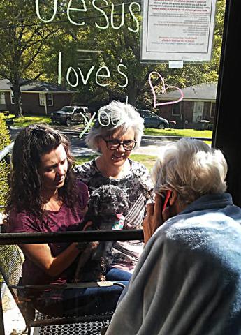 Photo submitted — A Hartwell Health and Rehab resident communicates with visitors through a window recently. 