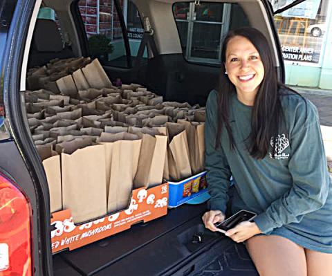 Photo submitted — Raleigh Whitworth poses for a photo with an SUV full of lunches prepared by Southern Hart Brewing Co. ready to deliver to the Nestle-Purina factory in Hartwell.