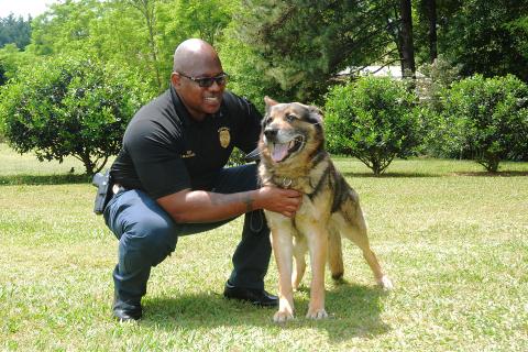 Sunshot by Michael Hall — Hartwell Police investigator Sherod Blackwell pets Justice, the recently retired K-9 unit Blackwell handled for all of Justice’s years of service to the department. Justice now lives with Blackwell as a pet. 