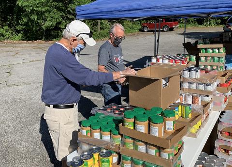 Photo submitted — Hartwell Rotary Club members Jerry Dawson, left, and Earl Johnson, right, help with a food giveaway by Hart Partners on May 6 at the Adult Learning Center on Benson Street in Hartwell. 