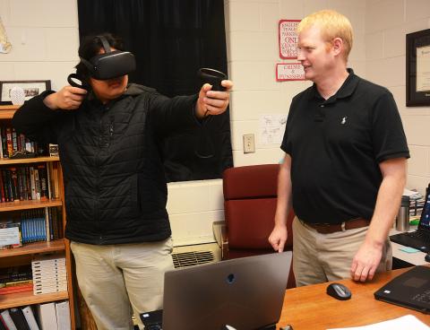 Sunshot by Michael Hall — Hart County High School’s STAR student, Sean Pak, left, and STAR teacher, Rob Elliot, right, demonstrate a virtual reality game in February that they had hands in creating. It is one of many stories from the Hart County Charter System covered by The Sun. 