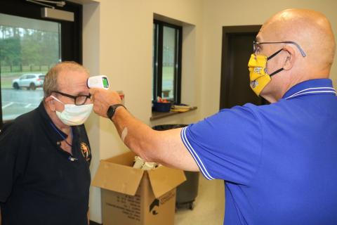 Sunshot by Grayson Williams — Voter Dominick Capobianco Jr. has his temperature checked by poll worker Gregory Wilson during early voting on Friday, May 22, at the Hart County Agriscience Center.