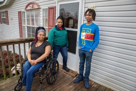 Photo by Stephanie Crump — Yolanda Feaster, left, poses for a photo with her children, Queasia, middle, and C.J., right. 