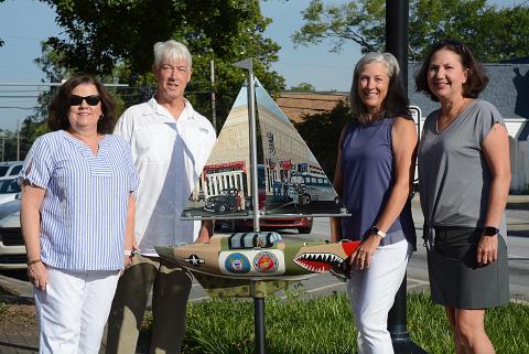 Sunshots by Michael Hall — From left to right, artist Debbie Gurley, Bo Howard, Tina Howard and artist Angela Short pose for a photo with the new sailboat installed Wednesday at Carolina and Howell streets to honor where service members boarded buses to go to World War II. The Howards spearheaded the fundraising for the project. 