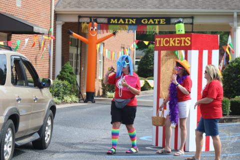 Sunshot by Grayson Williams Vacation Bible school teachers Jennifer Craft, left, Teresa Haygood, middle, and Kelie Worley, right are in costume pass out materials Thursday, June 18, at Hartwell First Baptist, to families participating in this year’s virtual VBS.