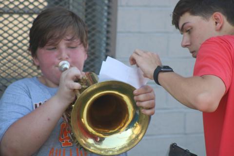 Sunshots by Grayson Williams — Hart County High School band captain Adam Walters, right, helps Caleb Reed, left with his music during the second day of band camp on Tuesday. 