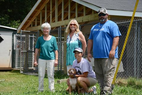 Sunshot by Michael Hall — Hart County Humane Society volunteers Judy Peebles, left, Pam McGovern, middle, Melanie Wood, kneeling with Mama Jenny, and Chad Wiloughby of Rock Solid Builders pose for a photo in front of the new covered outdoor run area for dogs at the J. Robert Mauldin Animal Sanctuary. 
