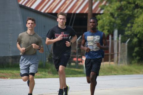 Sunshot by Grayson Williams — Colt Risner, Austin Little and Amahd Longworth run recently at Hart County Cross Country practice.