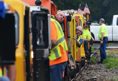 Phil Strine, of Canton, middle, peers out from the operator’s seat anticipating the start of the excursion. 