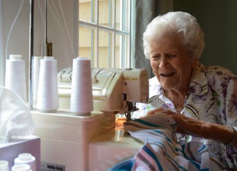 Sunshot by Michael Hall - Doris Mahannah works on a onsie for a newborn at her home in Hart County recently. Mahannah is 104 years old and contributes regularly to Tiny Stitches. 