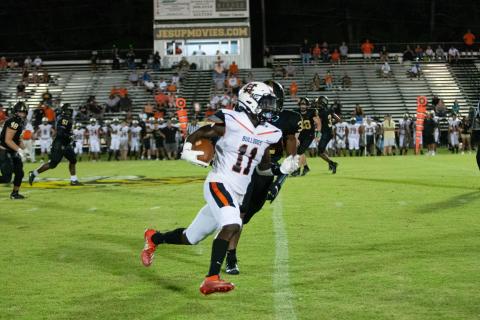 Photo submited by Davontay Wilson - Hart County’s Paul Davis tries to get around the edge after a catch on Friday, Sept. 4, against Wayne County in Jesup. The Bulldogs fell in their opener to the Yellow Jackets, 29-13.