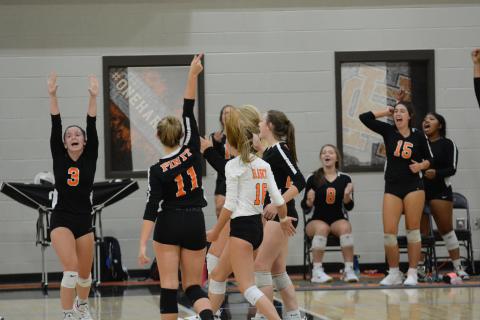 Sunshot by Grayson Williams - The Hart County Volleydogs celebrate on Tuesday, Sept. 15, at Hart County High School after a point in matches that ended with the team undefeated in Region 8-AAA and in first place. 