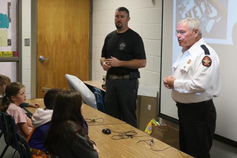 Sunshot by Grayson Williams - CHAMPS deputy Chris Carroll, left, and Hart County Sheriff Mike Cleveland speak to an elementary school class at South Hart Elementary School in 2019. 