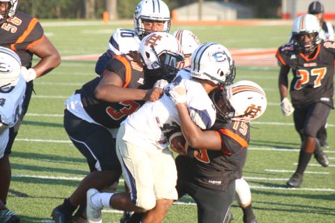 Pictured, several Bulldogs take down a Blue Devil ball carrier. 