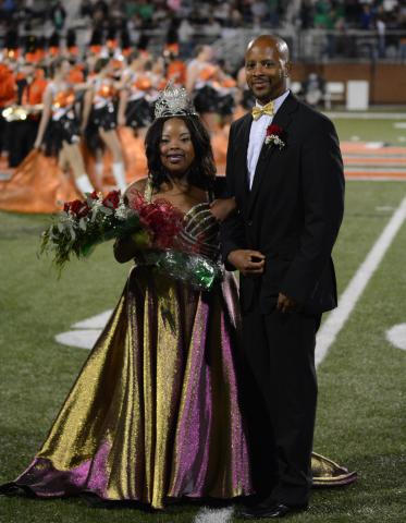 Taylor Freeman, left, smiles with her father and escort, Tyler Freeman, after being crowned the 2020 Homecoming Queen for Hart County High School on Friday, Oct. 16, at Herndon Stadium. 