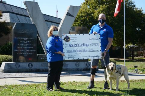 Sunshot by Michael Hall - Dawn Lemay, a Hartwell resident and state president of the Veterans of Foreign Wars Auxiliary, presents a check for $27,481.69 to Joe Worley, of America’s VetDogs, and his service dog Galaxie recently at the veterans memorial on the square at the Hart County Courthouse. 