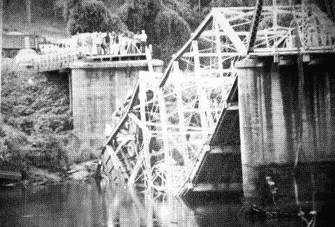 The Smith-McGee Bridge is shown collapsed in 1982.