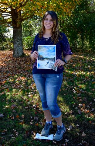 Photo by Kimberly Brown - Heather Conner, of Clayton, holds a copy of the cover of Lake Living Magazine and her $100 in prize money she won in a photo contest for the cover shot. 