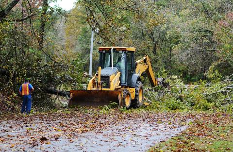 Sunshot by Michael Hall - A Hart County road crew clears a large tree that fell across Payne’s Creek Road on Oct. 29 after Tropical Storm Zeta passed through the area. 
