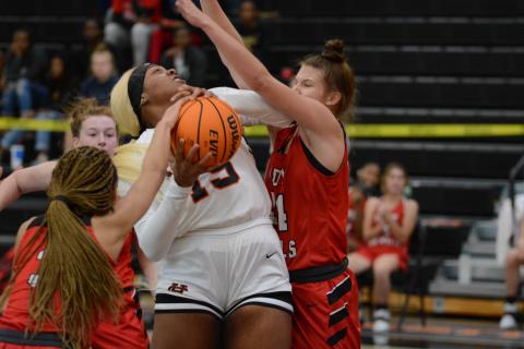 Sunshot by Grayson Williams - Taniya “Nesha” Alexander tries to power through Loganville defenders on Monday at Hart County High School during the McDonald’s Shootout. The Hart County Lady Dogs fell by one point on Tuesday in the semifinal game.